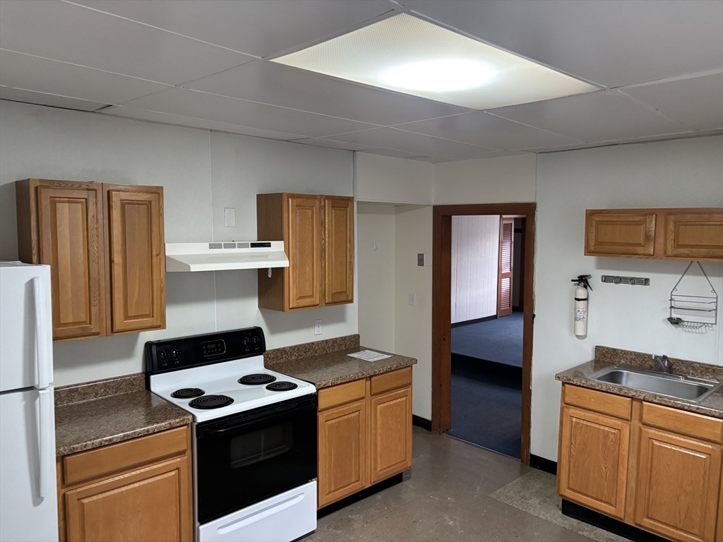a kitchen with a stove and a refrigerator