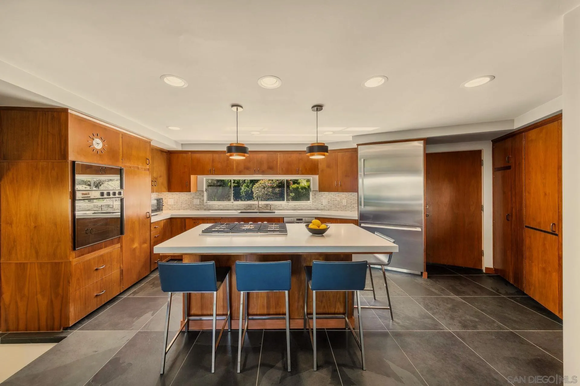 10446 Russell Road La Mesa, CA 91941 - Photo 15 of 75 a kitchen with stainless steel appliances kitchen island granite countertop a table and chairs in it