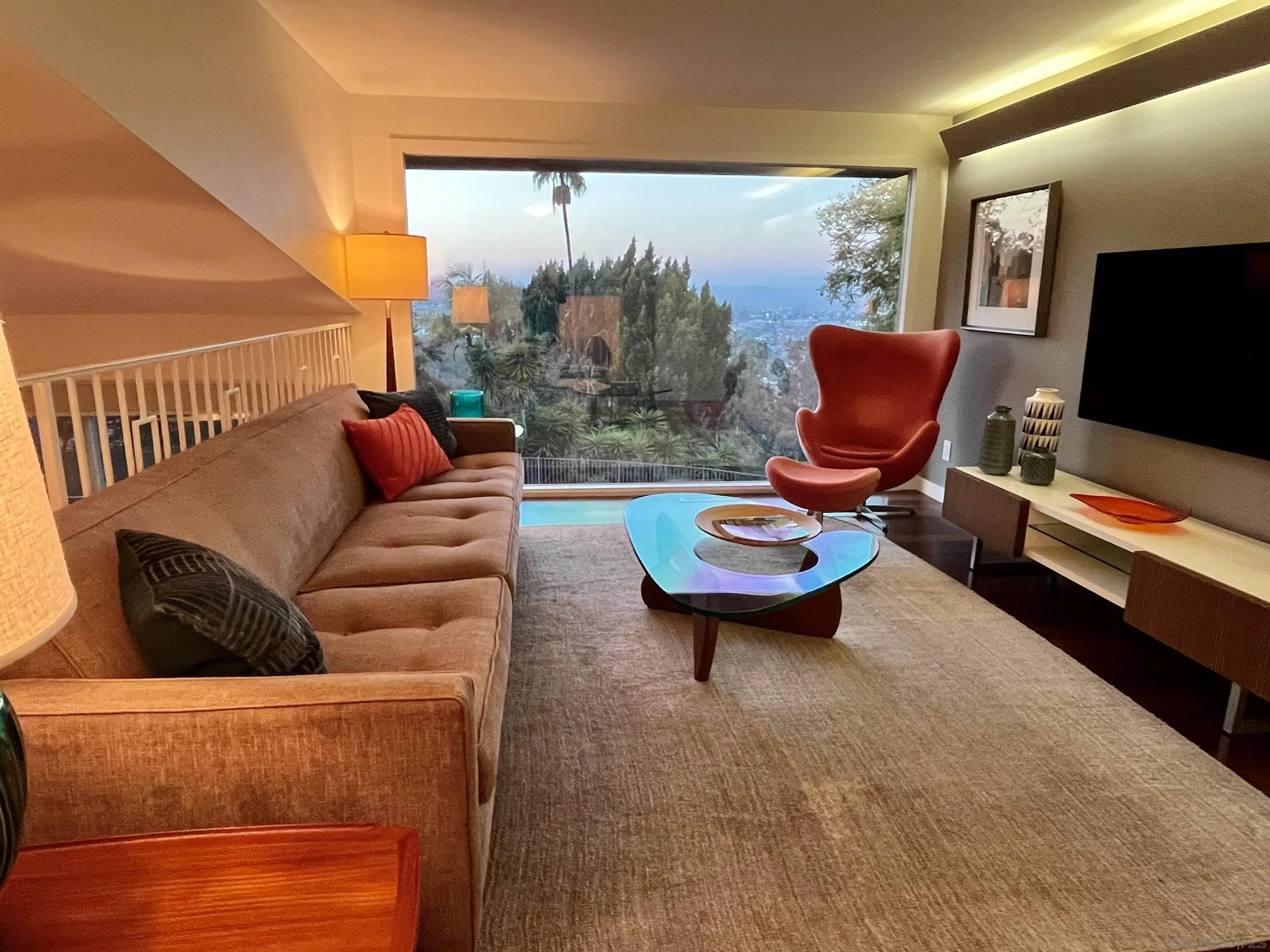 10446 Russell Road La Mesa, CA 91941 - Photo 22 of 75 a living room with furniture a flat screen tv and a floor to ceiling window