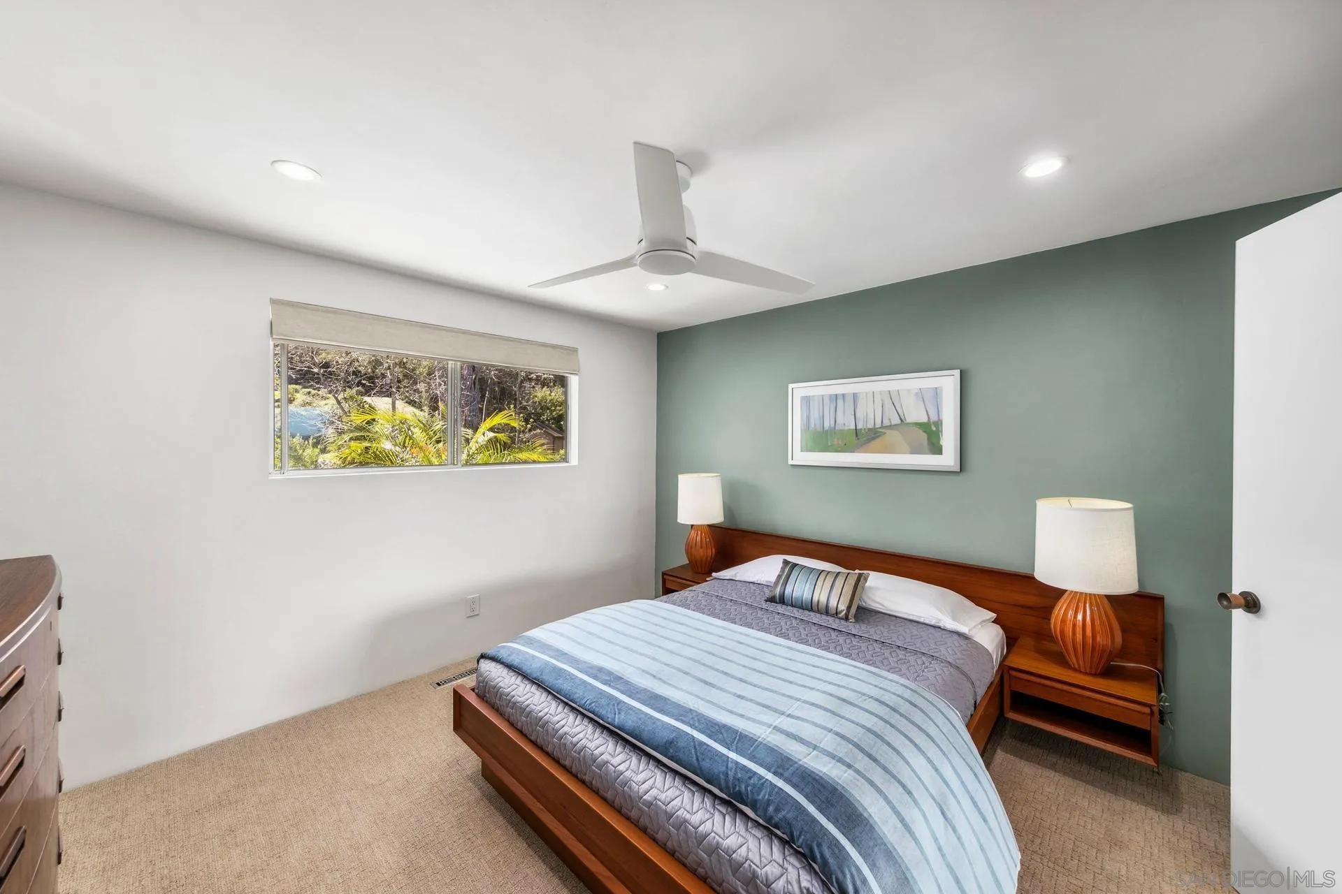 10446 Russell Road La Mesa, CA 91941 - Photo 36 of 75 a bedroom with a bed and a lamp on table