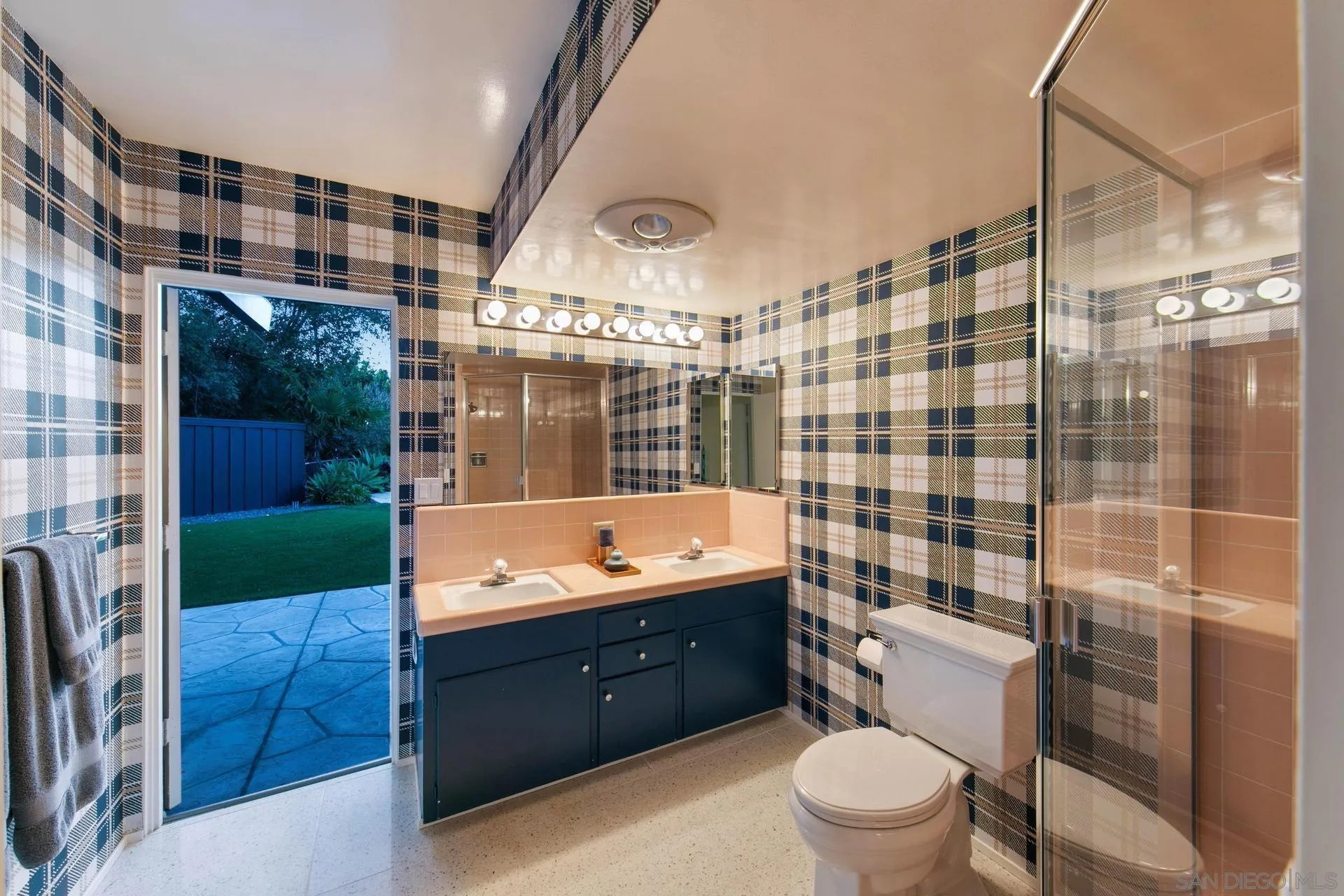 10446 Russell Road La Mesa, CA 91941 - Photo 55 of 75 a bathroom with a sink a toilet a mirror and shower