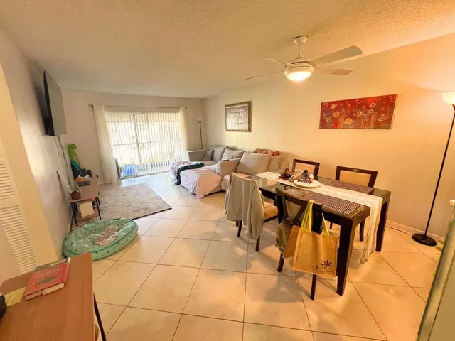 a living room with couches a coffee table and a flat screen tv