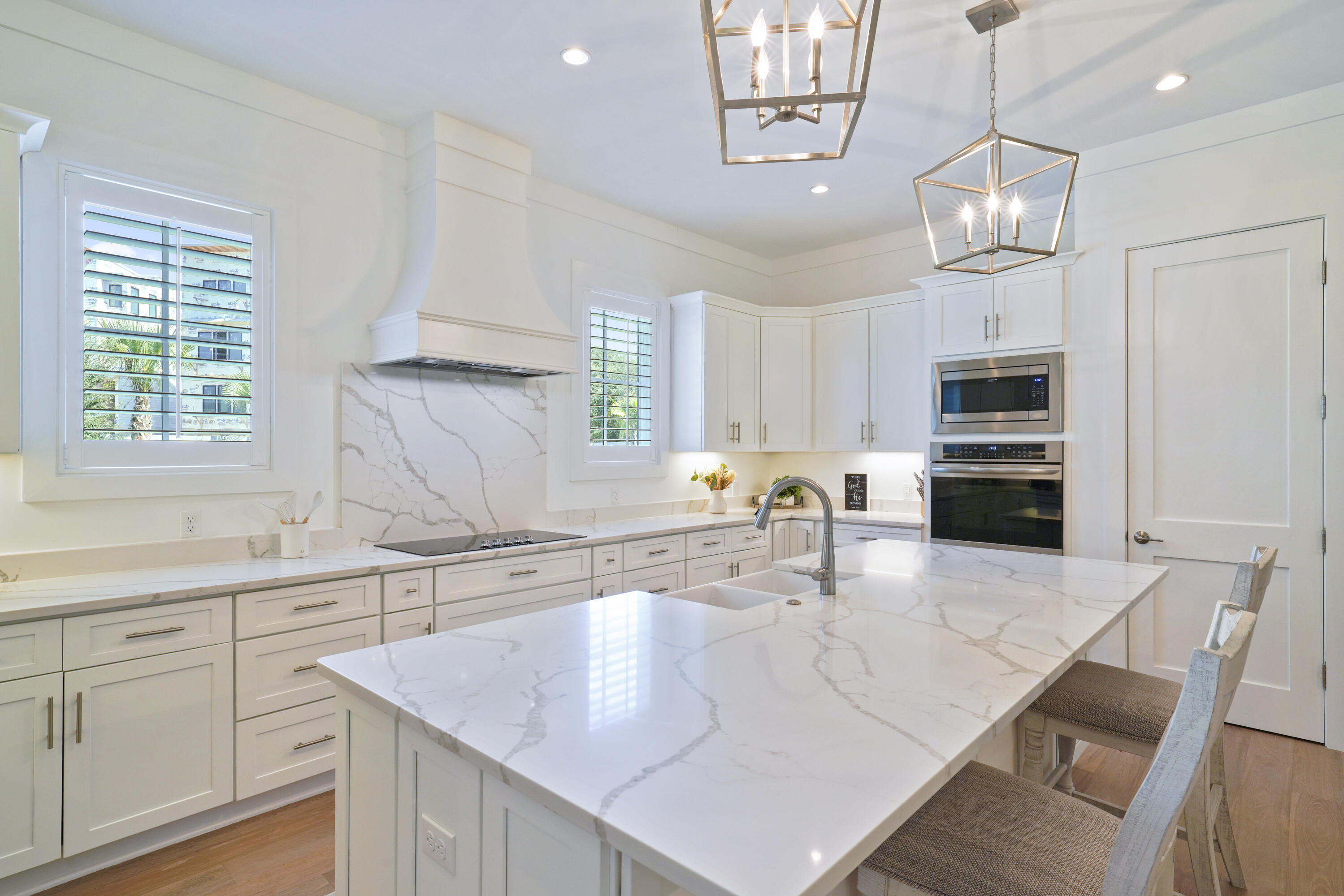76 Tanglewood Drive Santa Rosa Beach, FL 32459 - Photo 19 of 94 a kitchen with stainless steel appliances granite countertop a sink a microwave oven a stove and white cabinets with wooden floor
