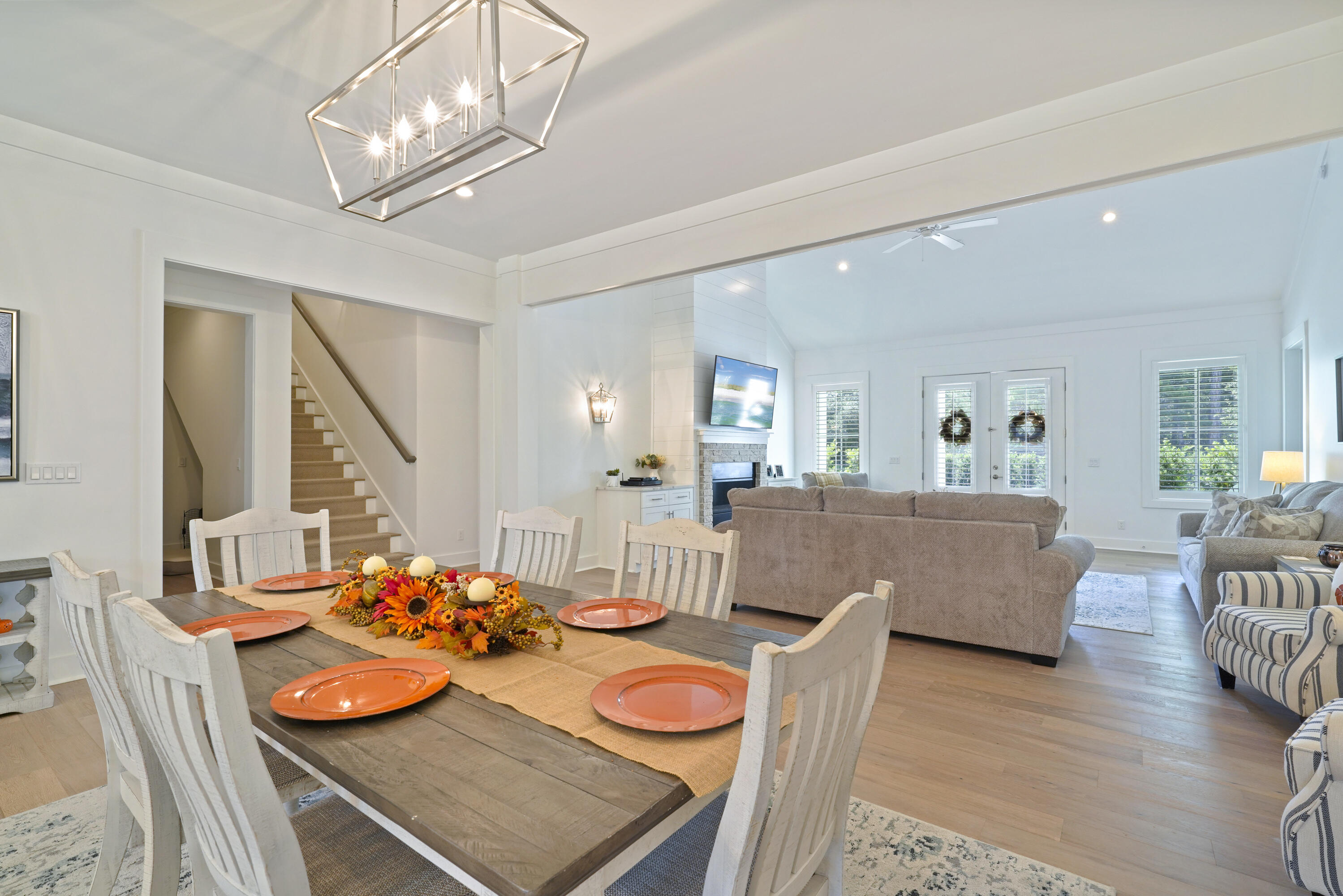 76 Tanglewood Drive Santa Rosa Beach, FL 32459 - Photo 27 of 94 a living room with furniture and a dining table with wooden floor