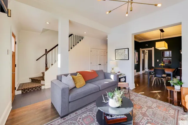 a living room with furniture and a chandelier
