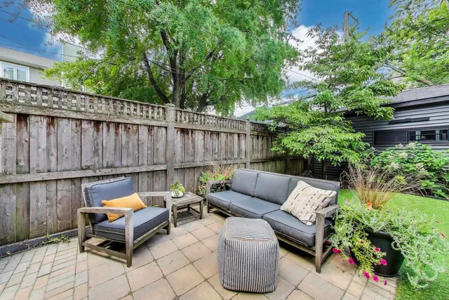 a backyard of a house with outdoor seating