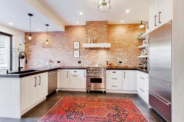 a large kitchen with stainless steel appliances kitchen island granite countertop a sink and cabinets