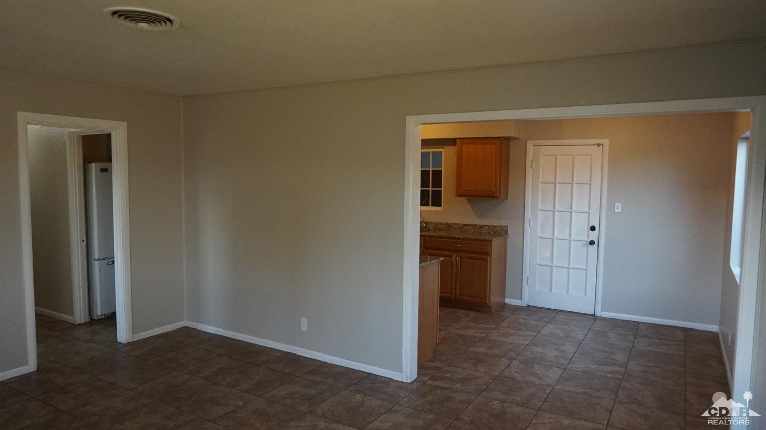 82342 Adobe Road Indio, CA 92201 - Photo 3 of 26 an empty room that has a grey walls