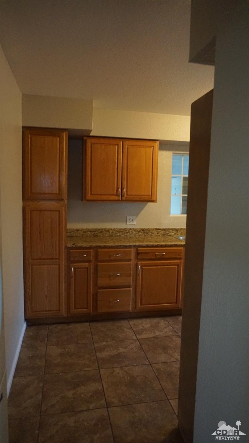 82342 Adobe Road Indio, CA 92201 - Photo 8 of 26 a kitchen with a refrigerator and cabinets