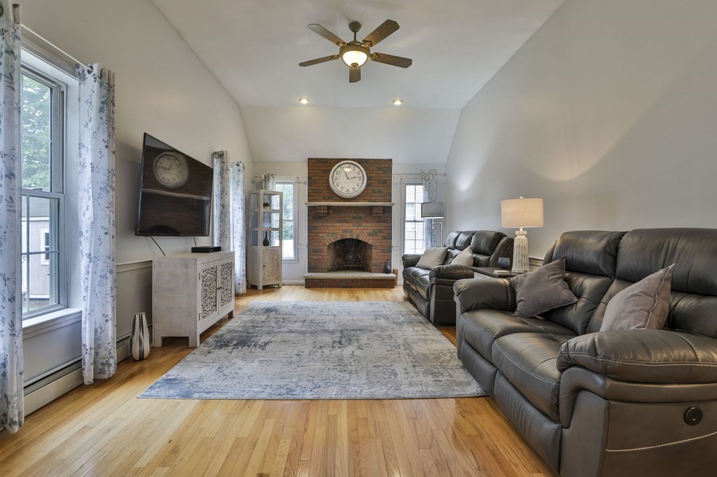 5 Hancock Road Windham, NH 03087 - Photo 11 of 41 a living room with furniture a fireplace and a flat screen tv