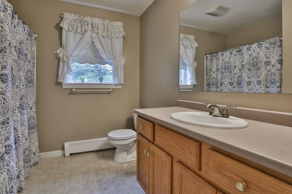 5 Hancock Road Windham, NH 03087 - Photo 29 of 41 a bathroom with a granite countertop sink a toilet and a mirror