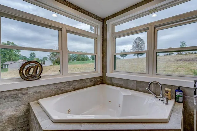 a bath tub sitting in front of a window