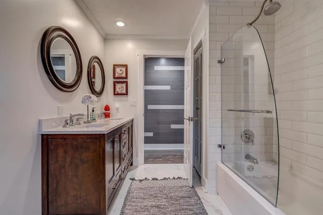 a bathroom with a bathtub a mirror a sink and a shower