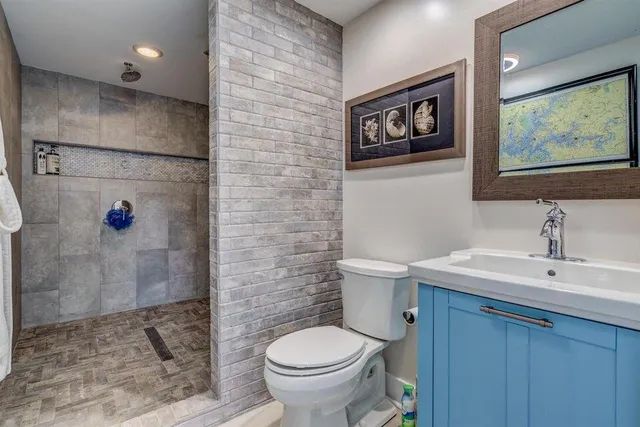 a bathroom with a toilet sink and vanity