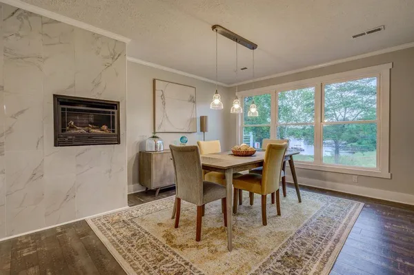 a view of a dining room with furniture window and wooden floor