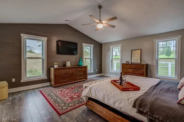 a bedroom with a bed and flat screen tv