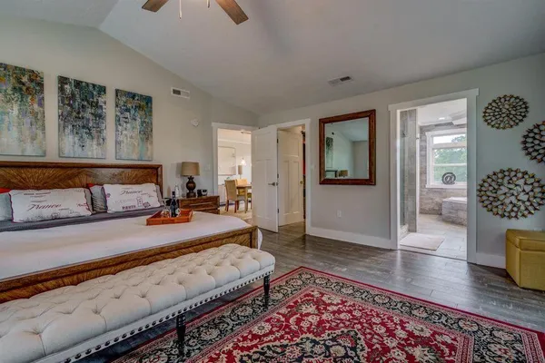 a bedroom with furniture and wooden floor