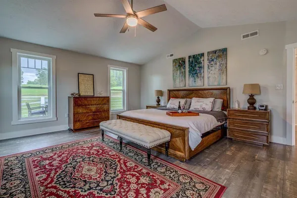 a bedroom with a bed dresser and a window