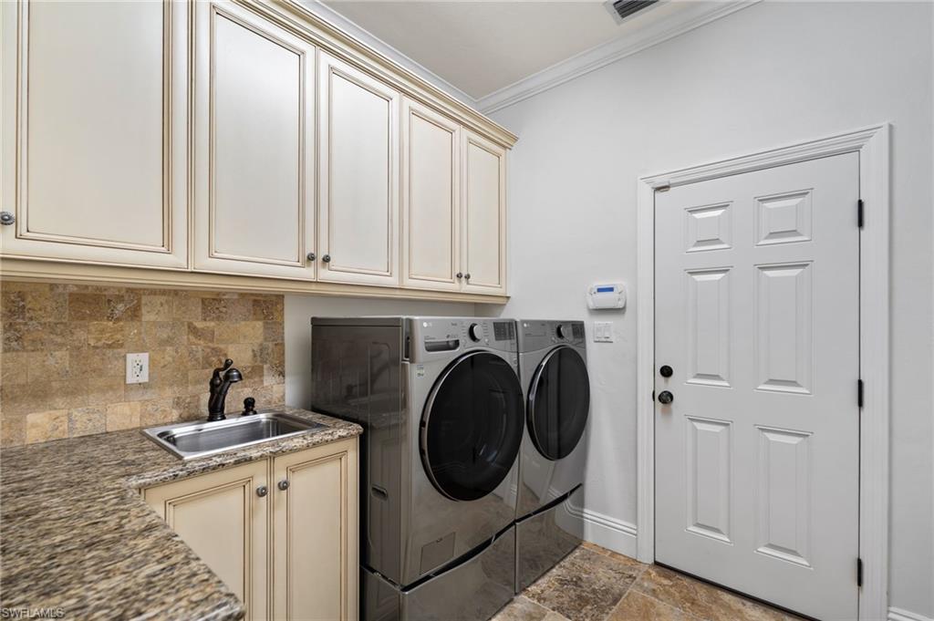 2201 Beacon Lane Naples, FL 34103 - Photo 21 of 25 a utility room with sink dryer and washer