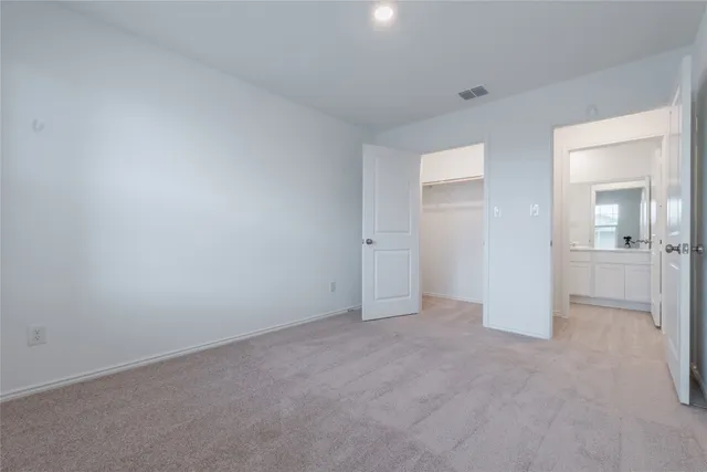 a kitchen with cabinets and wooden floor