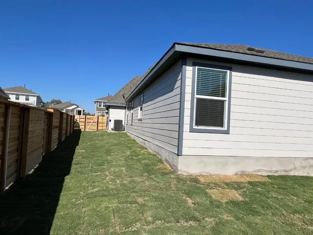 a view of a house with backyard and deck