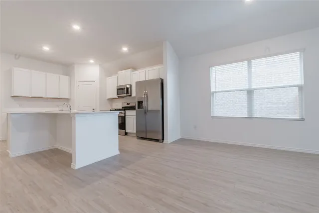 a view of a kitchen with a sink and a window