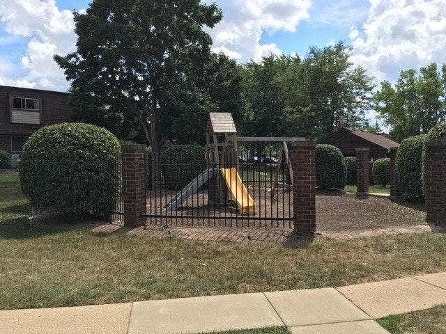 2526 Berkshire Court, Unit 2526 Waukegan, IL 60087 - Photo 16 of 16 a view of a house with a small yard and wooden fence
