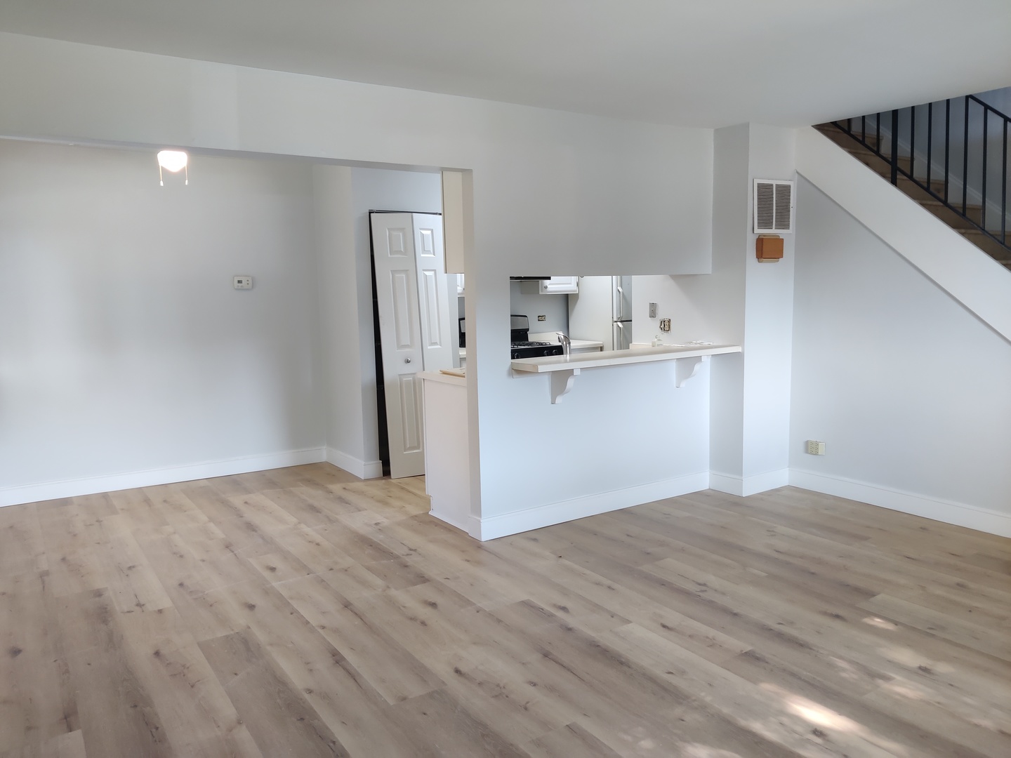 2526 Berkshire Court, Unit 2526 Waukegan, IL 60087 - Photo 3 of 16 a view of a kitchen with wooden floor and a refrigerator