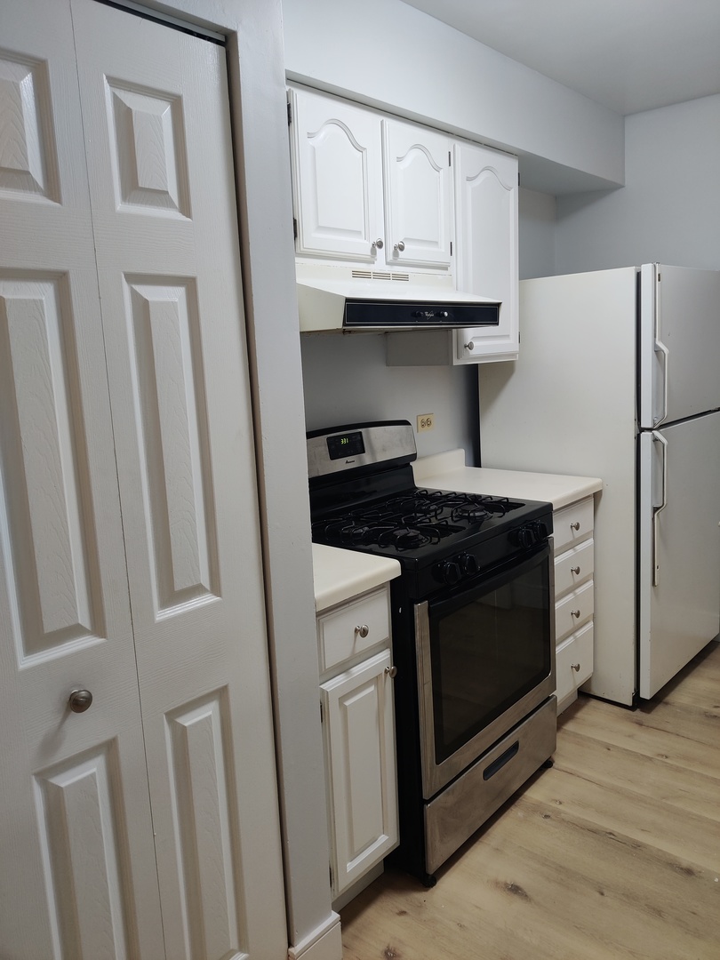 2526 Berkshire Court, Unit 2526 Waukegan, IL 60087 - Photo 5 of 16 a kitchen with stainless steel appliances white cabinets and a stove