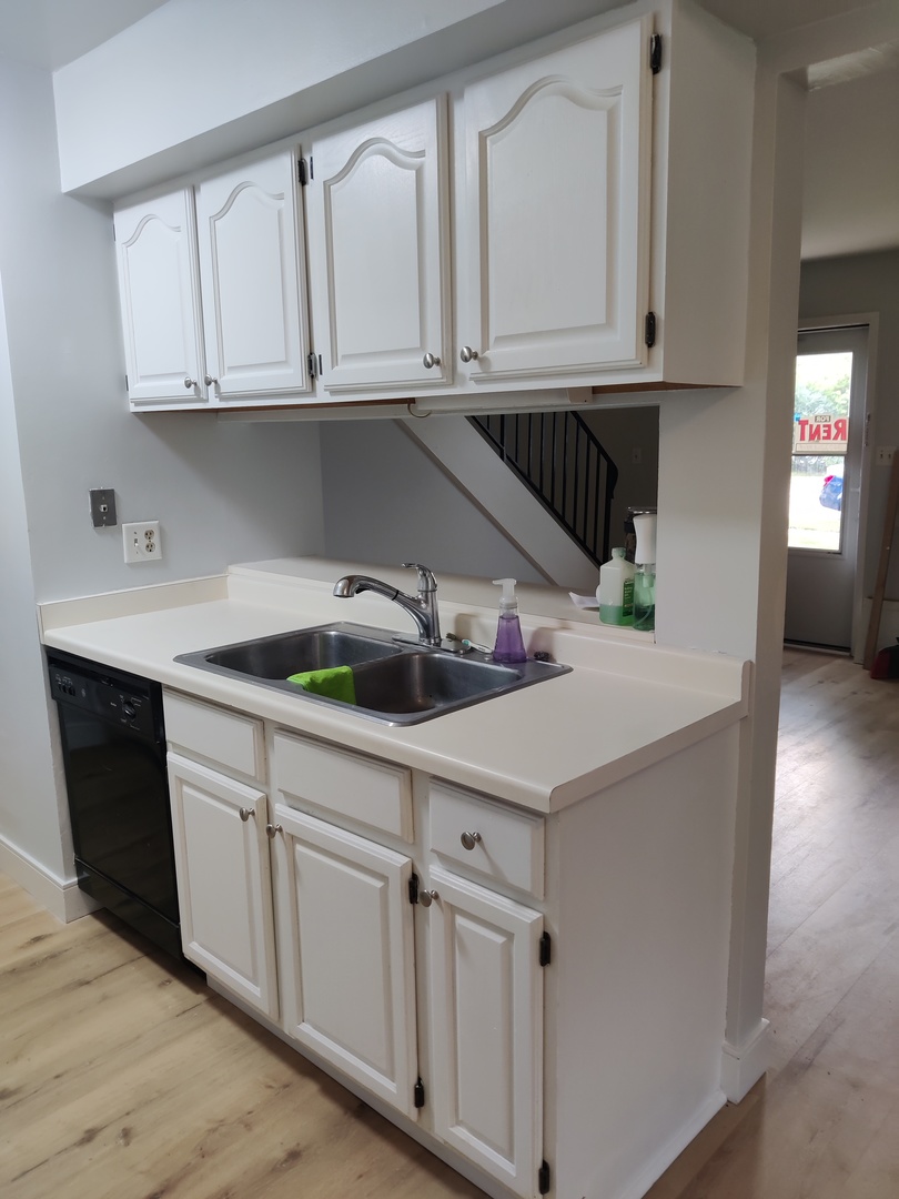 2526 Berkshire Court, Unit 2526 Waukegan, IL 60087 - Photo 6 of 16 a kitchen with white cabinets and a sink