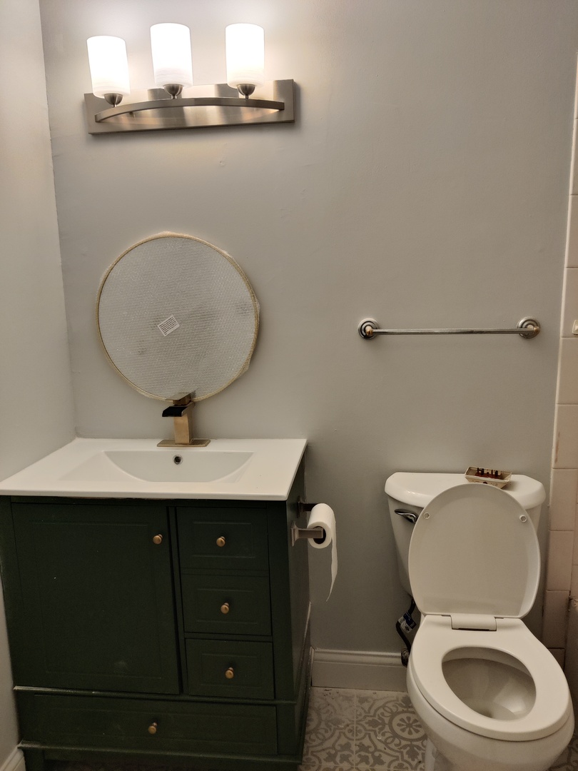 2526 Berkshire Court, Unit 2526 Waukegan, IL 60087 - Photo 9 of 16 a bathroom with a toilet a sink and mirror