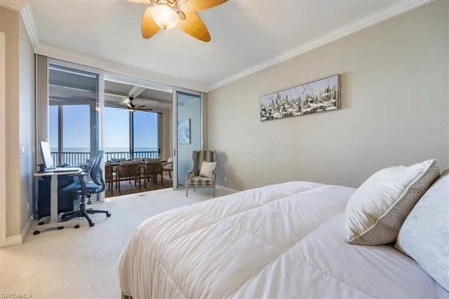 a bedroom with a bed couch and a large window