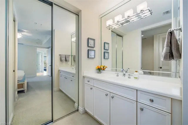 a spacious en suite bathroom with double sink and a mirror