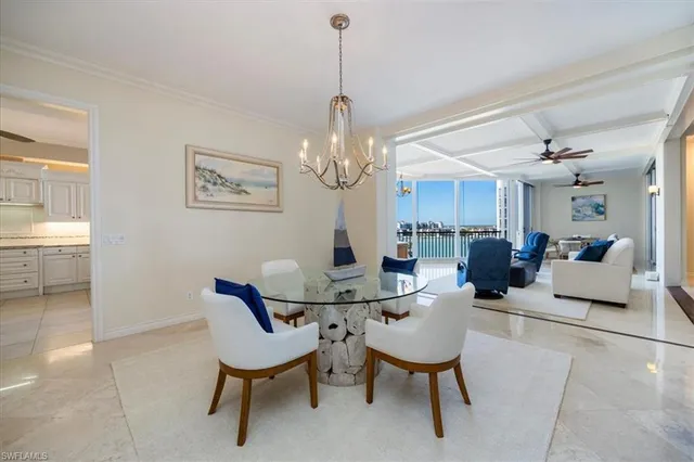 a living room with furniture chandelier and a rug