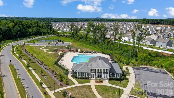 a view of a swimming pool with seating area and furniture