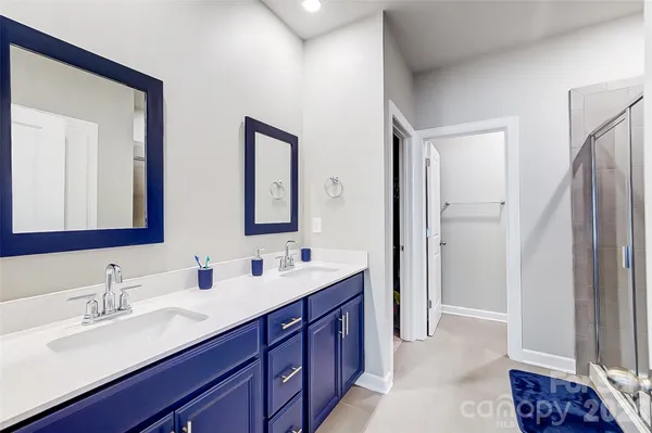 a bathroom with double vanity sinks and a mirror