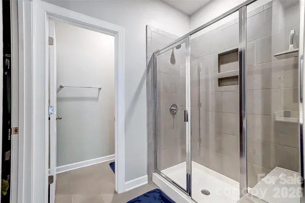 a bathroom with a glass shower door