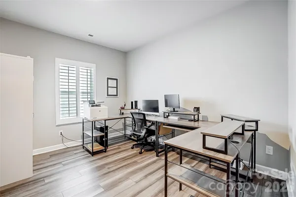 a view of a workspace with furniture and a window