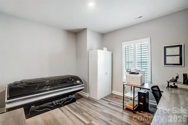 a living room with furniture gym equipment and a window