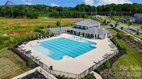 a view of a swimming pool with seating area and furniture