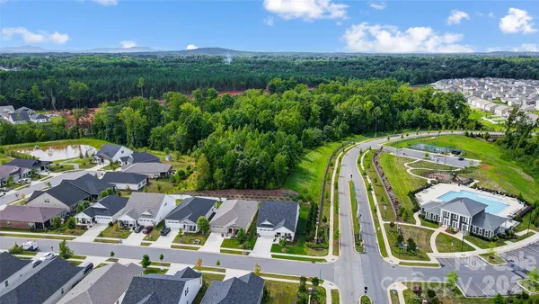 an aerial view of a house with garden space and lake view