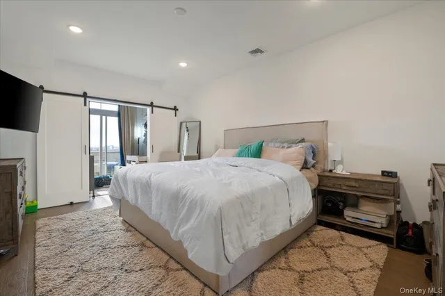 a bed room with a bed and a television