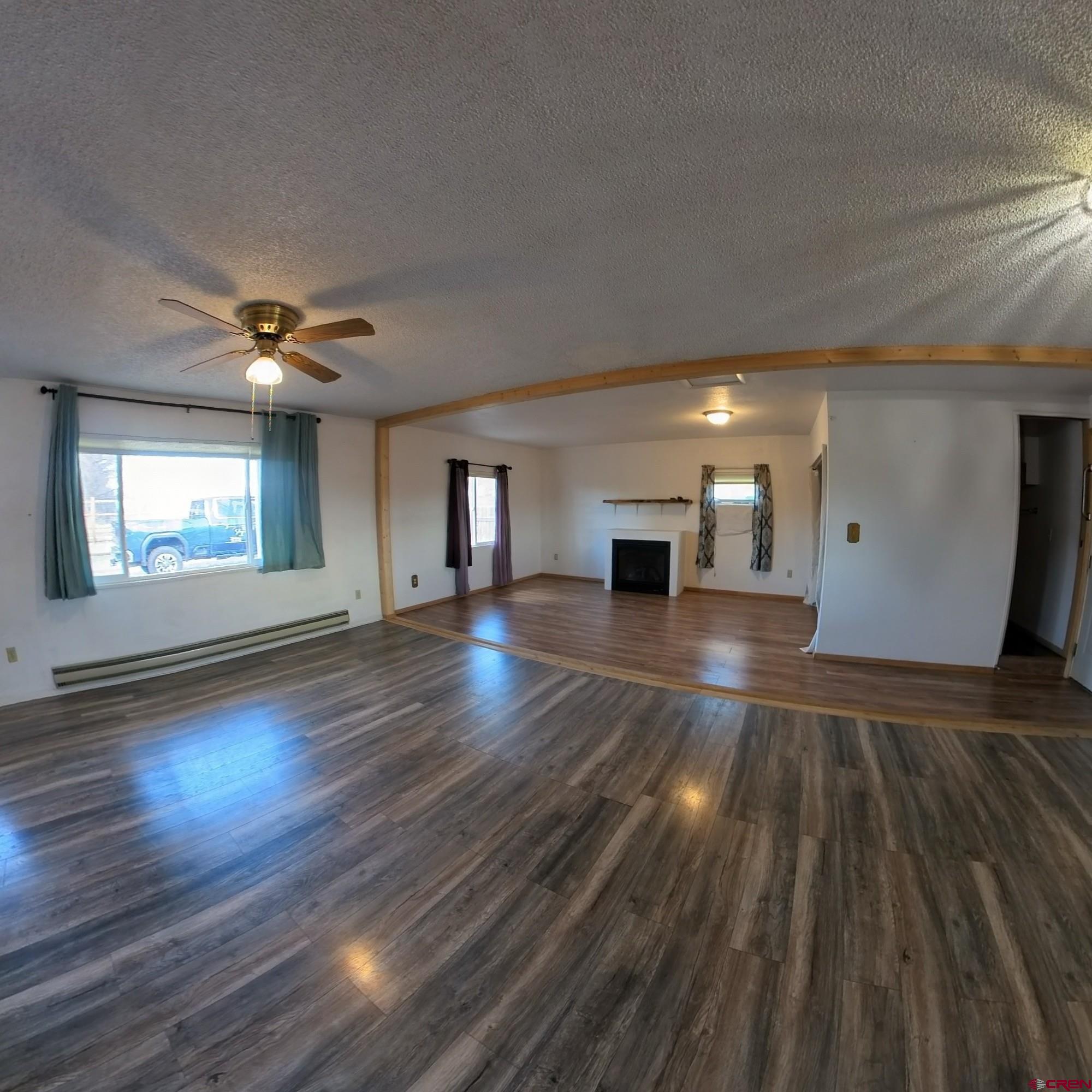 20268 Fairview Road Austin, CO 81410 - Photo 8 of 19 a view of an empty room with wooden floor and a window