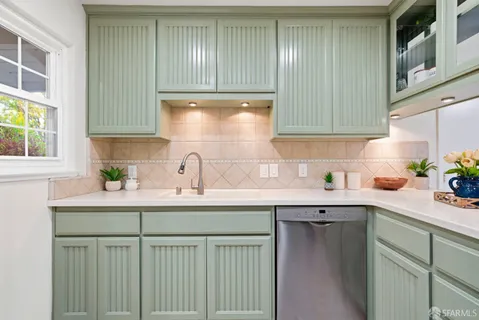 a kitchen with a stove refrigerator and microwave