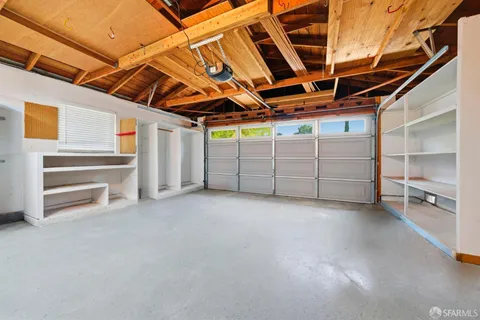 a view of backyard with wooden fence and a slide