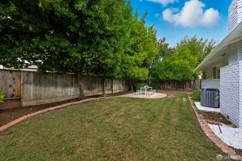 a view of a backyard with sitting area