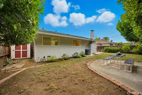 an aerial view of a house with a yard pool and outdoor seating