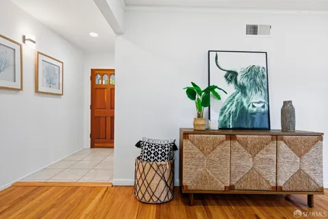 a view of room with furniture and wooden floor