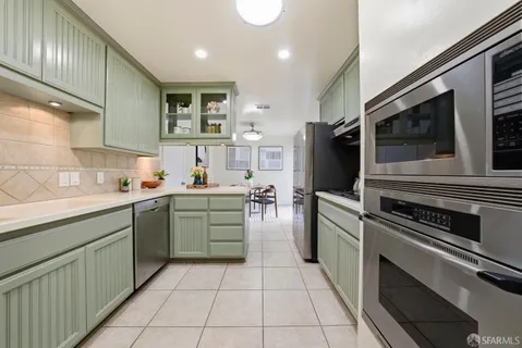 a kitchen with a sink stainless steel appliances and cabinets