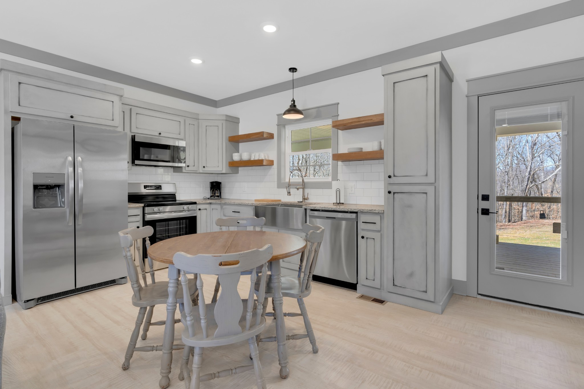591 Ghea Road Normandy, TN 37360 - Photo 27 of 48 a kitchen with granite countertop a center island and stainless steel appliances